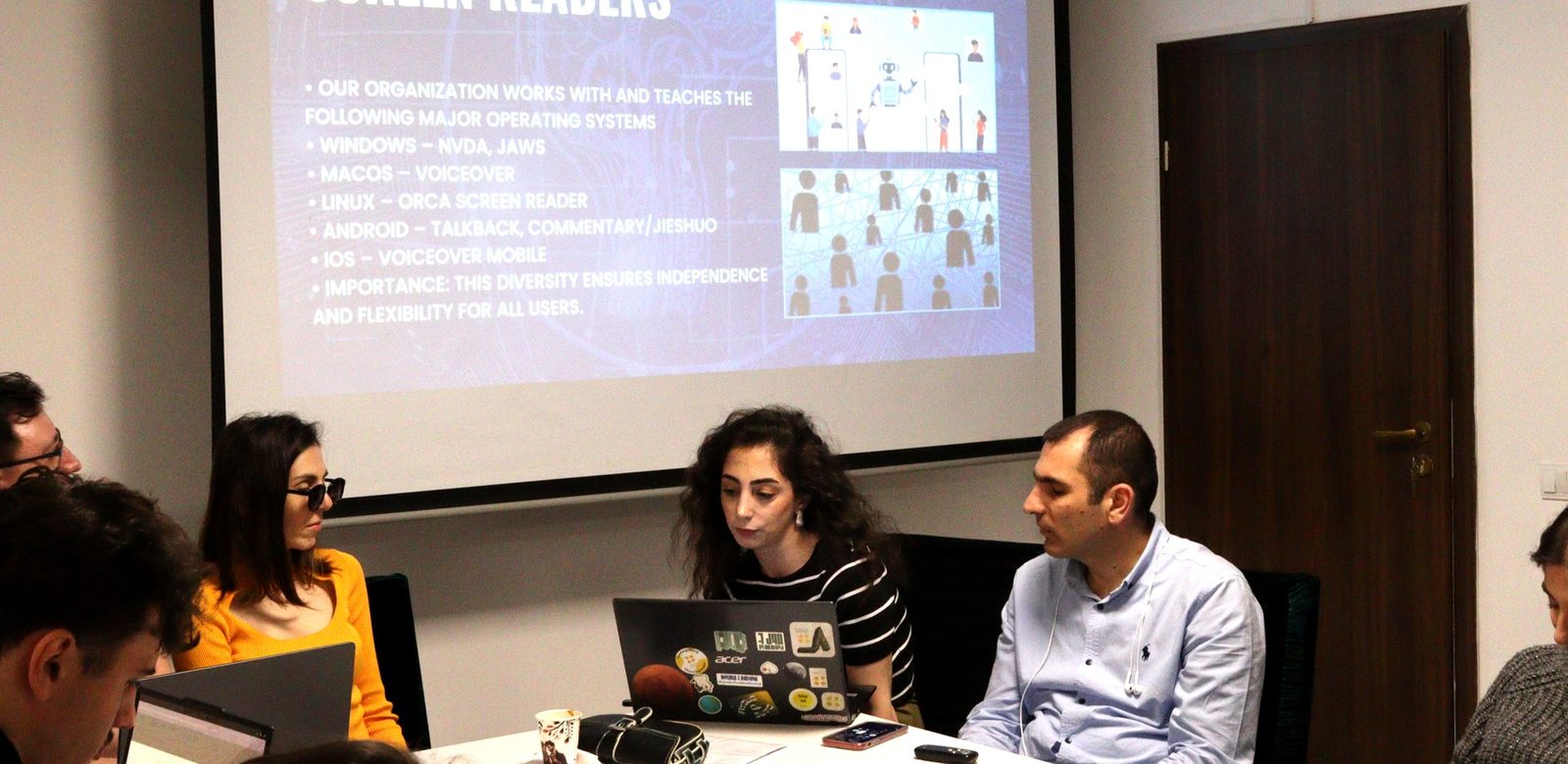 The White Cane team presenting Armenia, seated under a slide about screen readers.