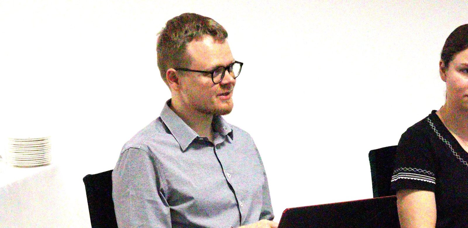 The Osvěta team presenting the Czech system, seated with a laptop while the group listens.