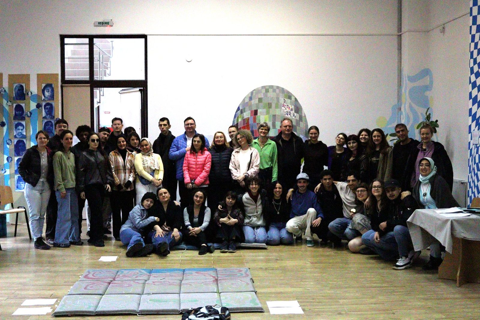 The international VISION team — youth workers from the six partner countries — standing together, smiling, during the training course in Iași.